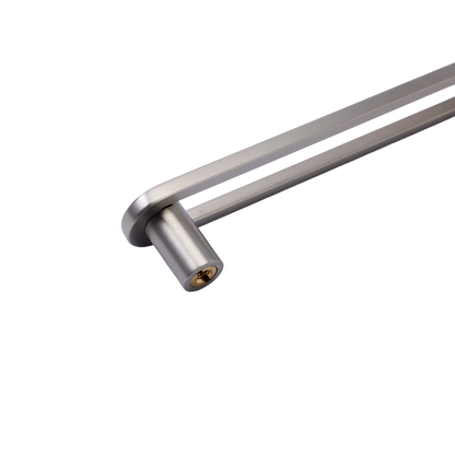 Close-up of Landon Pull showcasing its cylindrical handle and mounting hardware on a white geometric background