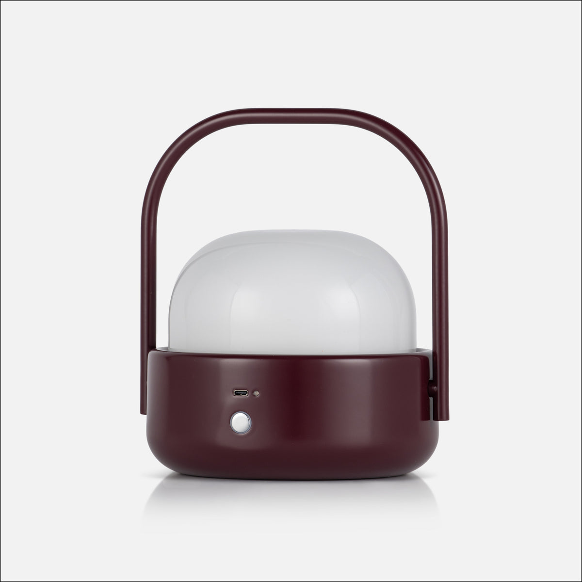 Front view of Cooper table lamp showcasing burgundy finish, white diffuser, curved handle, and front controls on a white background