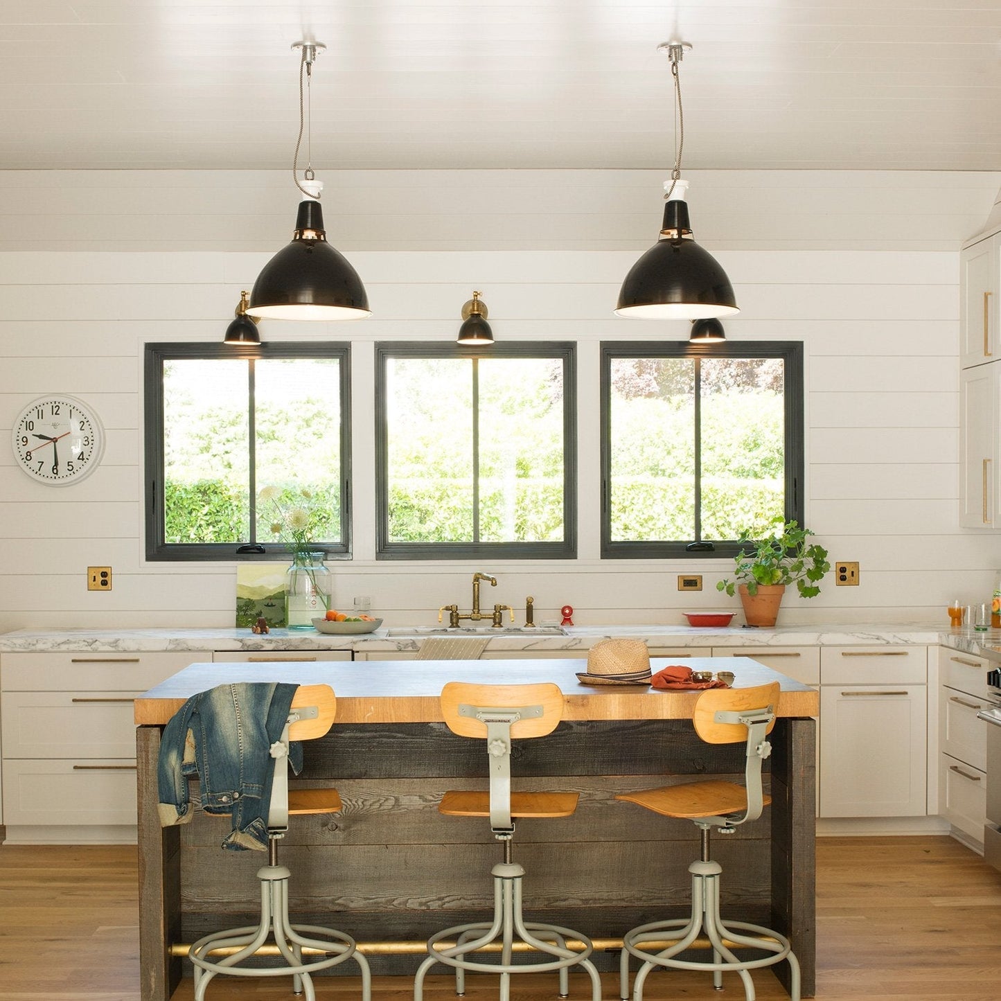 Kitchen featuring Edgecliff Pull cabinet hardware on white cabinetry and a wood island
