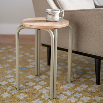 Close-up of Sundrop Rug showcasing graphic tossed flowers on a vivid chartreuse background beneath a side table and chair