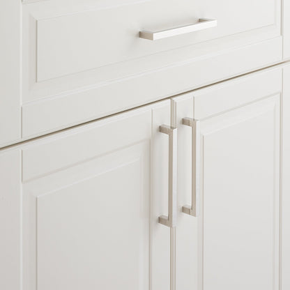 Close-up of Edgecliff Pull showcasing long rectangular hardware on white paneled cabinets