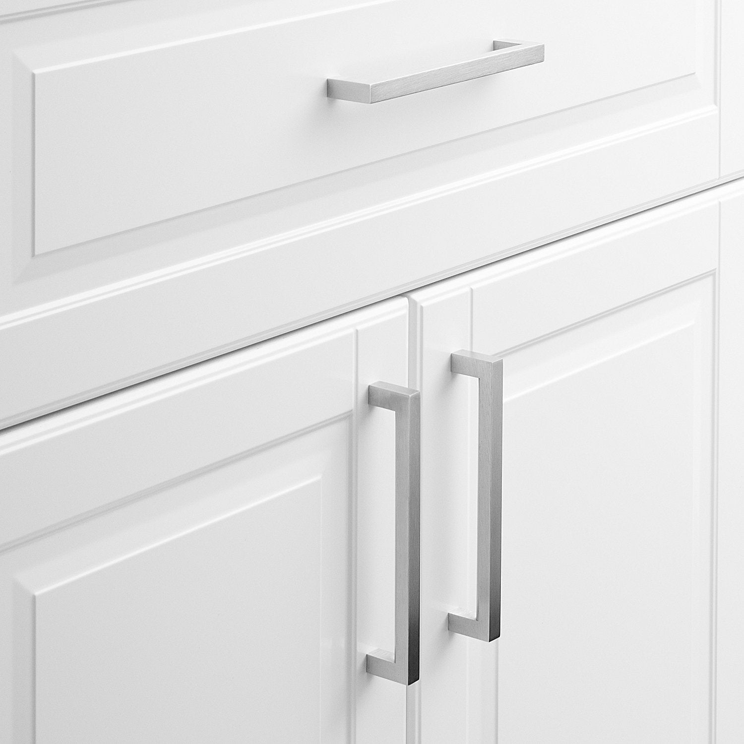 Close-up view of Edgecliff Pull showcasing long rectangular cabinet pulls on white paneled cabinets