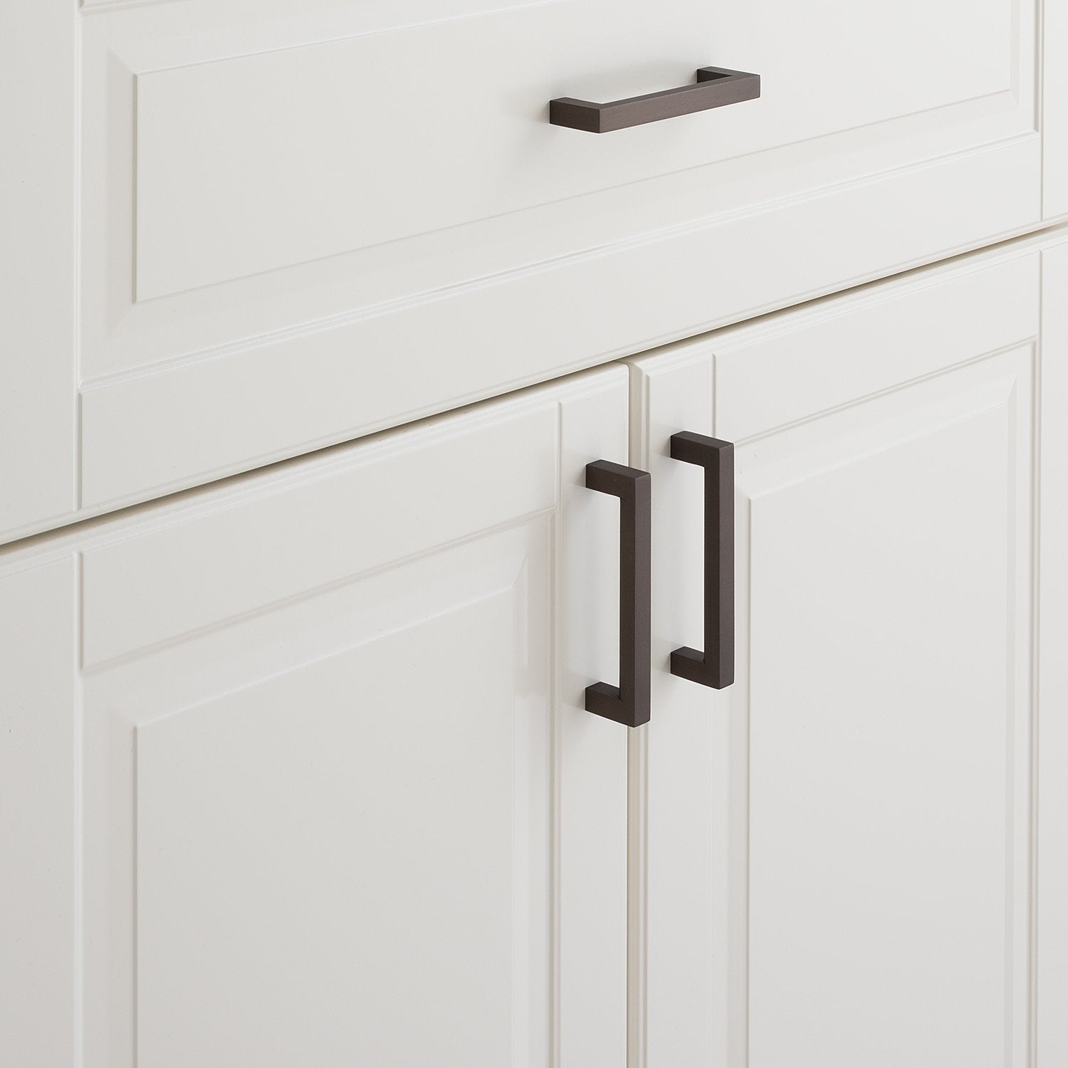Close-up of Edgecliff Pull showcasing dark rectangular bar pulls on white paneled cabinetry