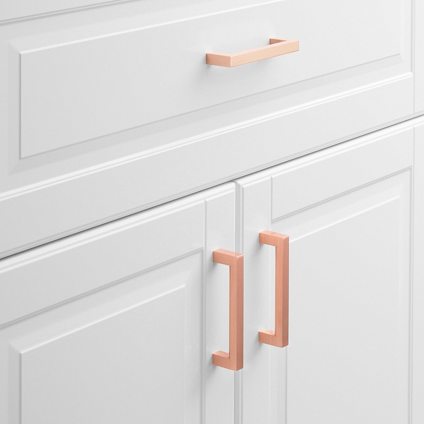 Front view of Edgecliff Pull showcasing an angular rectangular design on white paneled cabinet doors