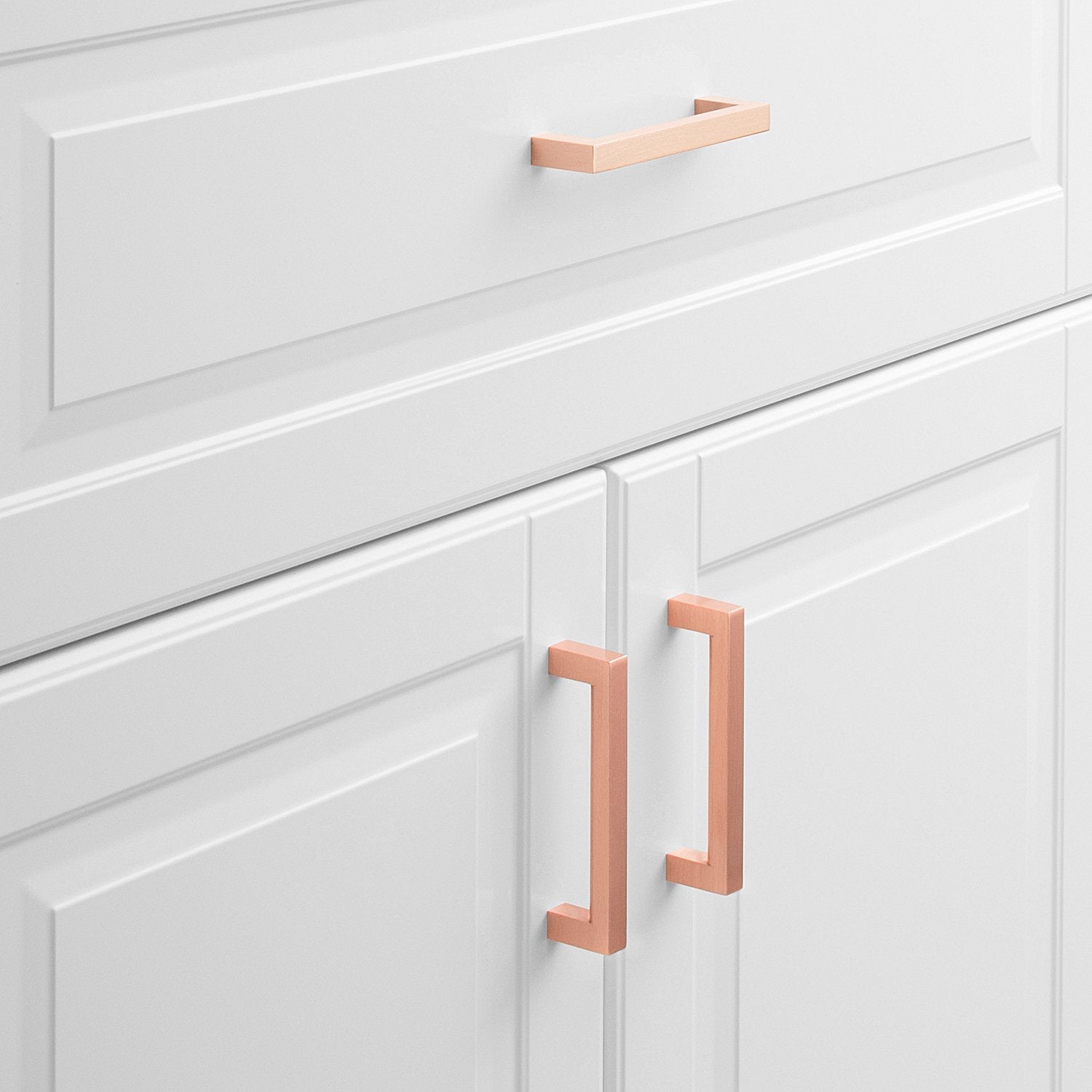 Front view of Edgecliff Pull showcasing an angular rectangular design on white paneled cabinet doors