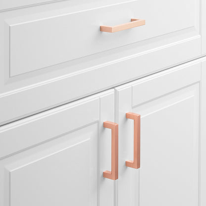 Front view of Edgecliff Pull showcasing an angular rectangular design on white paneled cabinet doors