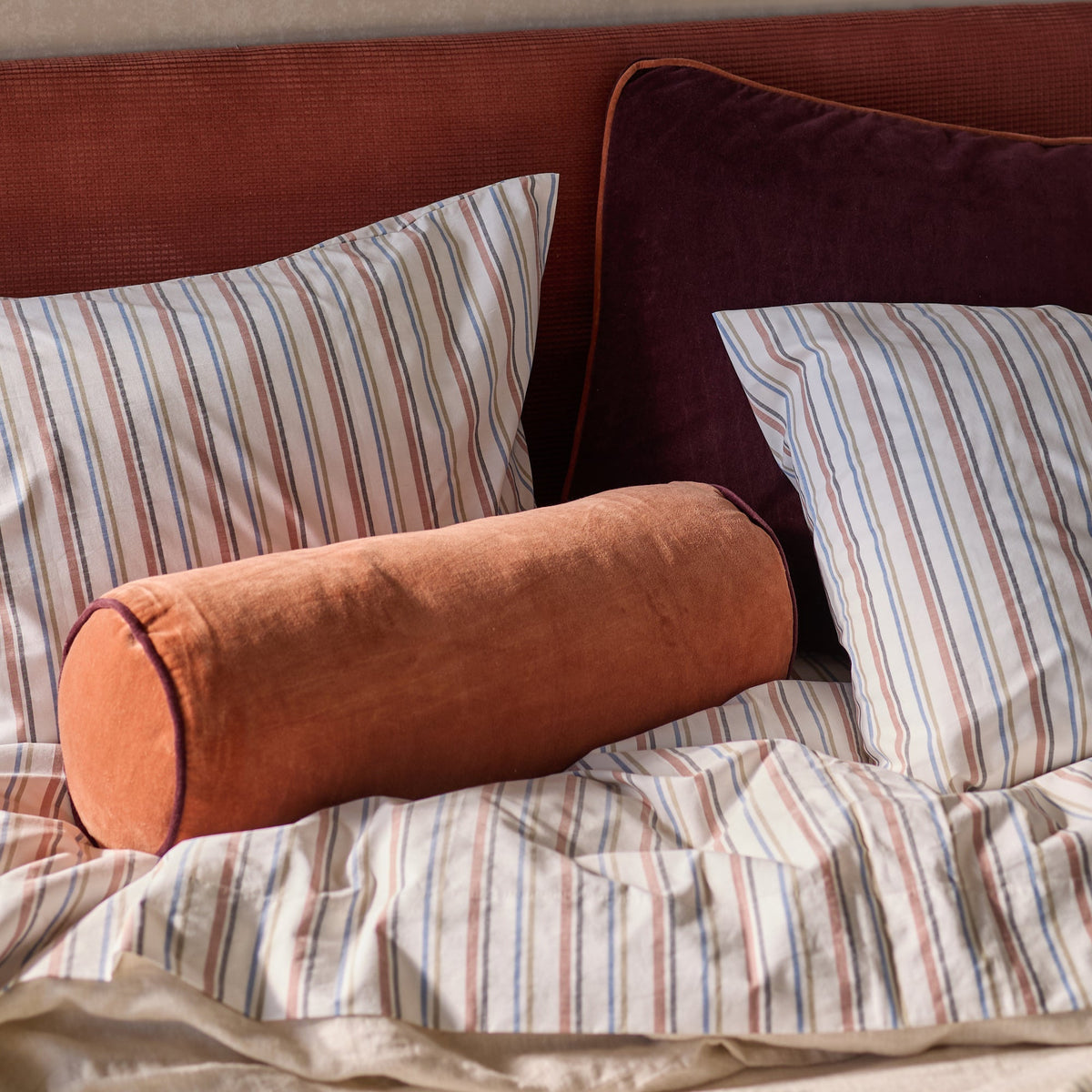 Close-up of Fresh Stripe Pillowcases showcasing classic multicolor stripes on a styled bed