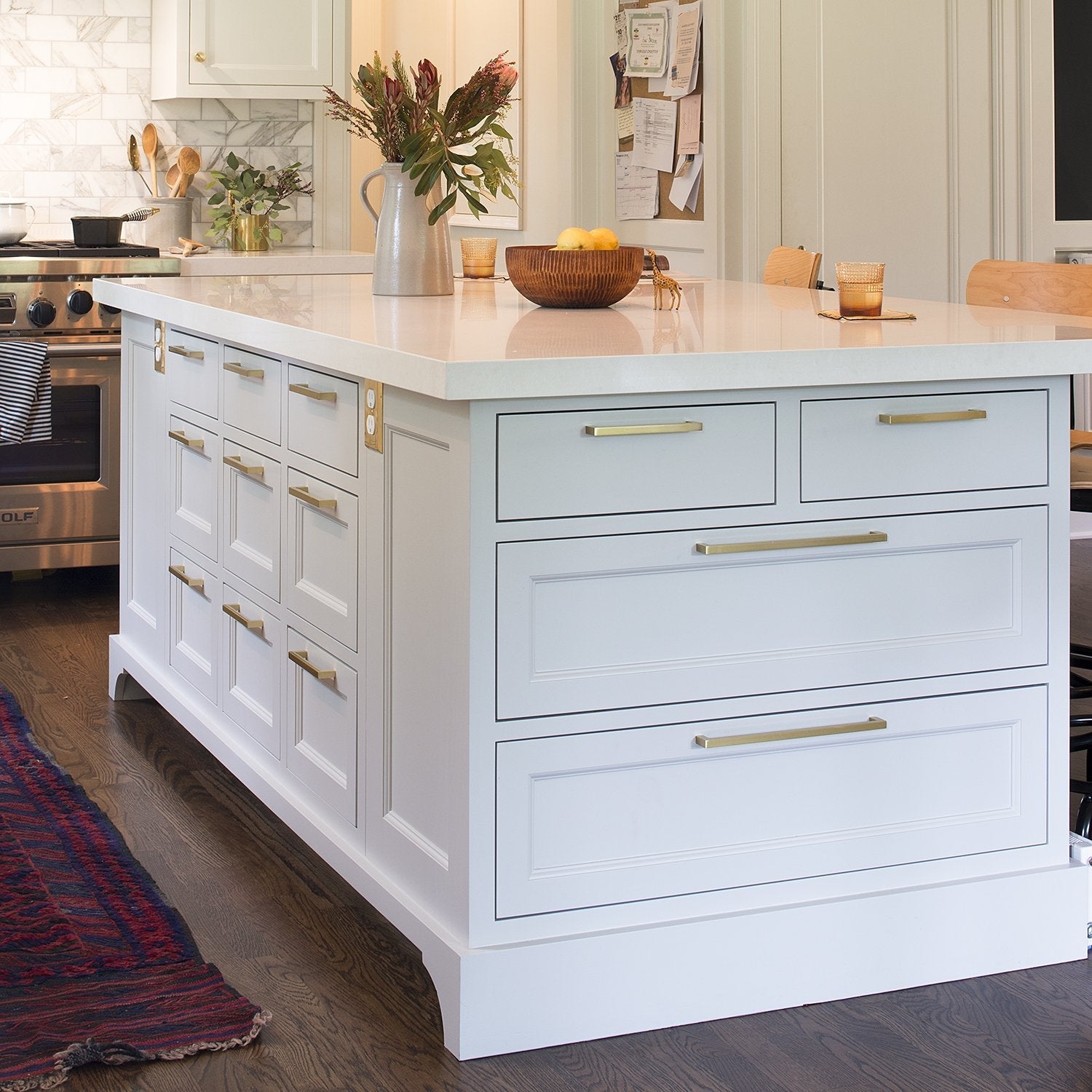 Lifestyle view of Edgecliff Pull showcasing installation on white kitchen cabinetry in a bright kitchen