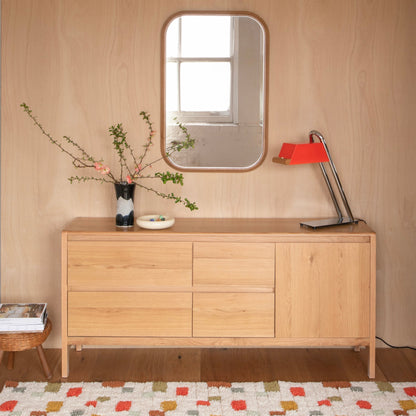 Front view of Pixel Rug showcasing its geometric pattern and plush high pile in a room with a wood credenza