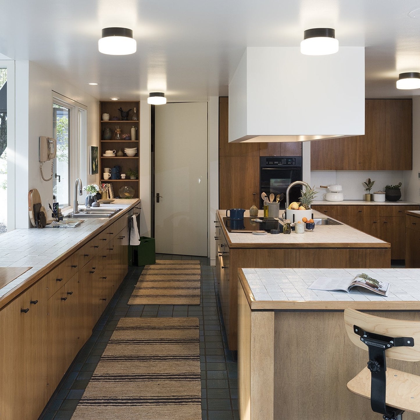 Modern kitchen showcasing True Black T Pulls on wood cabinets and island