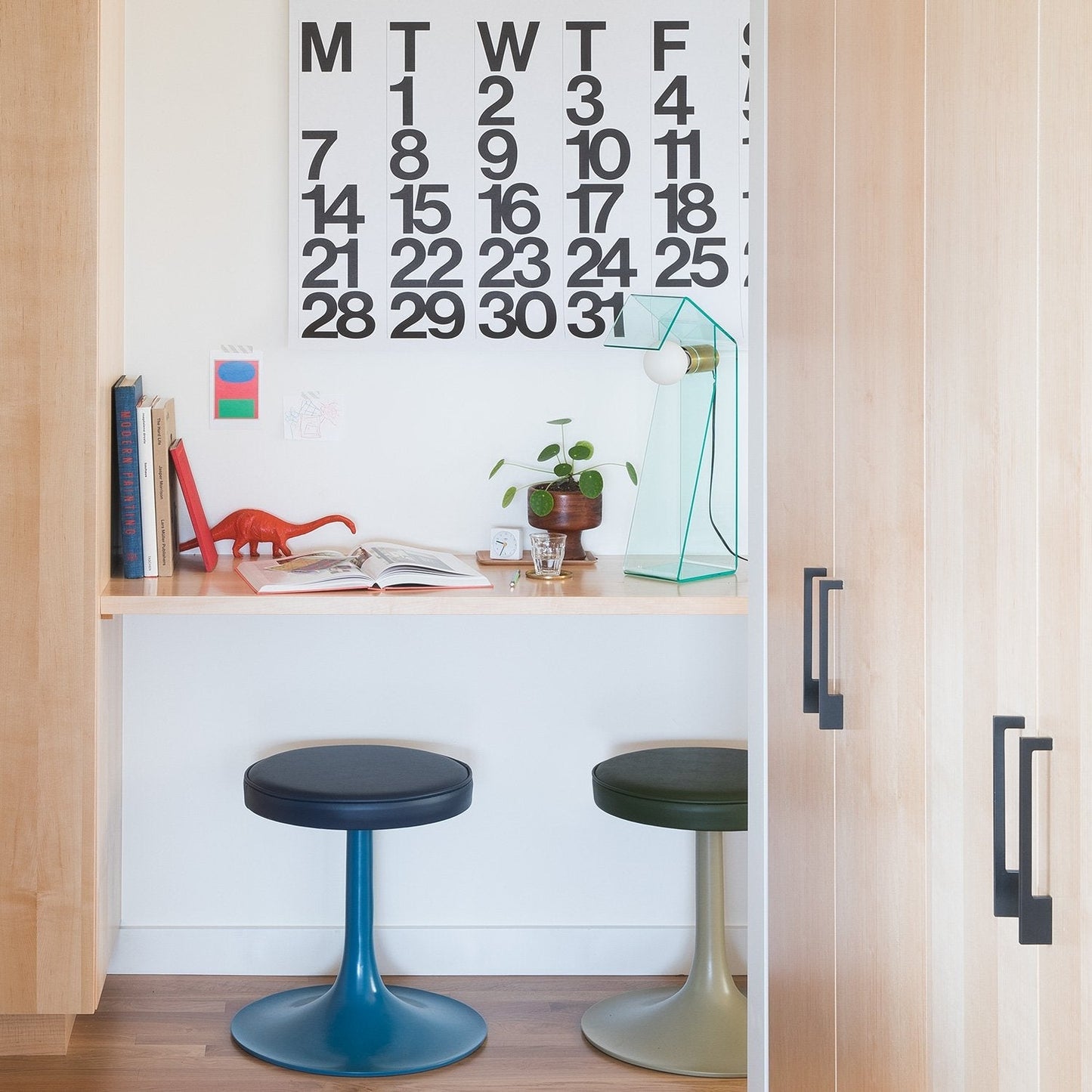 Alberta Pull cabinet handles mounted on light wood cabinetry in a bright modern kitchen