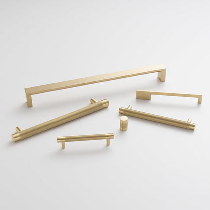 Overhead view of Knurled Pull cabinet hardware showcasing gold-tone bar pulls in several sizes on a white background