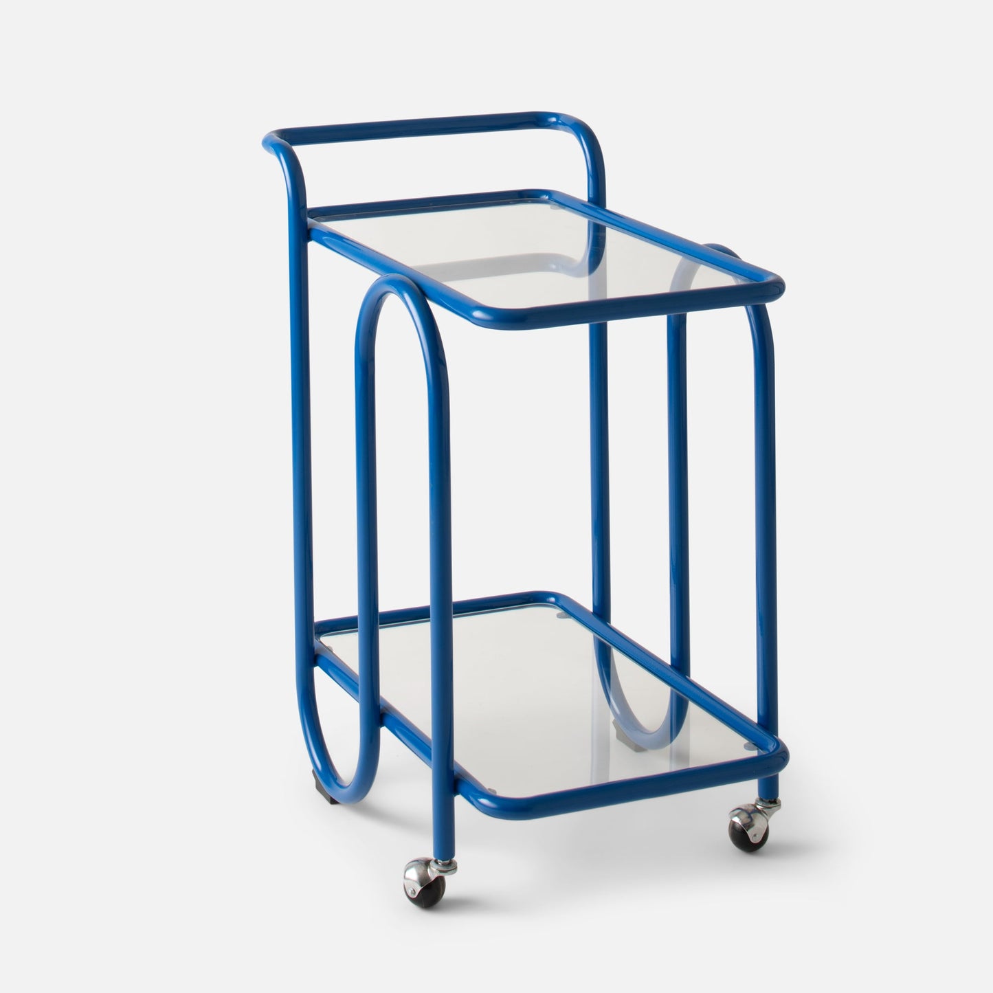 Quarter view of Lolly Bar Cart showcasing cobalt gloss bent-steel frame, tempered glass shelves, and caster wheel on white background
