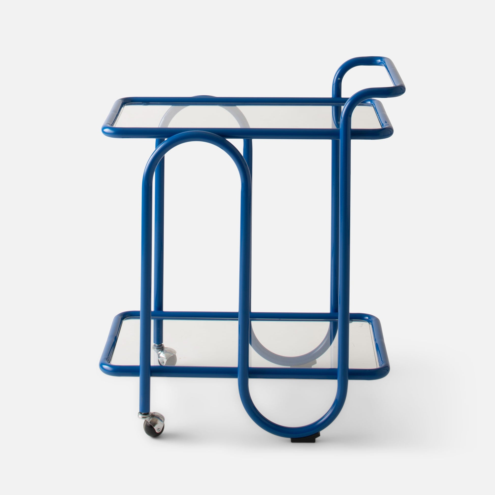 Front view of Lolly Bar Cart showcasing cobalt gloss bent steel frame, two tempered glass shelves and caster wheels on white background